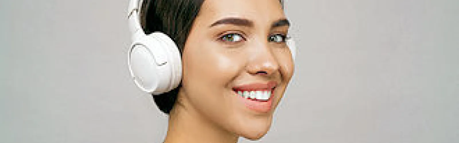 Woman with headphones listening to audio